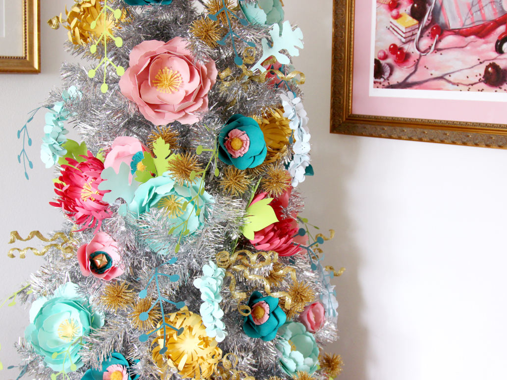 Silver Christmas tree with pastel floral decorations.