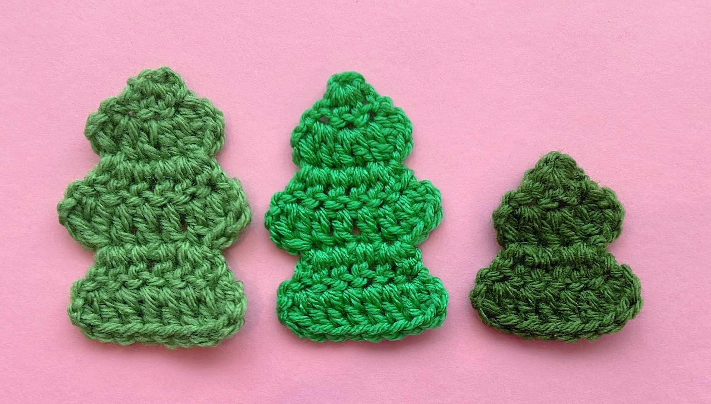 3 small crocheted christmas tree appliqués in different shades of green